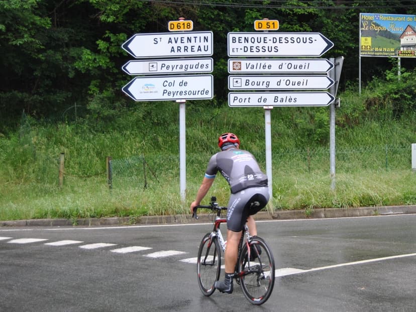 Cyclist op bergweg bij zonsondergang